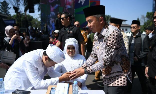 Penjabat Gubernur Jawa Barat Bey Machmudin menjadi saksi nikah pada kegiatan nikah massal dalam rangkaian West Java Festival 2024 di kawasan Gedung Sate, Kota Bandung, Sabtu (24/8/2024).(Foto: Rizal FS/Biro Adpim Jabar)