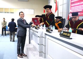 FOTO : Dadang Rohandi saat menerima sertifikat kelulusan dari ketua sidang usai meraih gelar doktor  di UIN SGD Bandung/Jumat,28 Agustus 2026/bedanews.com/istimewa